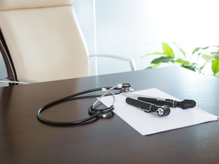 table with medical equipment and a office chair