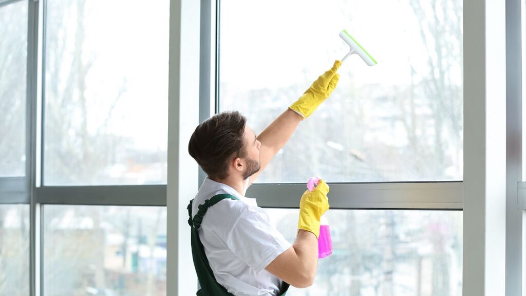 male cleaning staff cleaning out windows