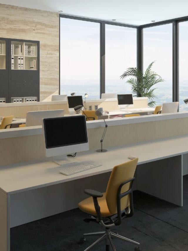 image of a minimalistic commercial office space with white tables, computers and a few yellow chairs