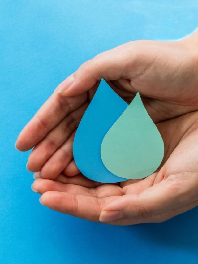 office water conservation showed with paper droplets of water being held by two hands