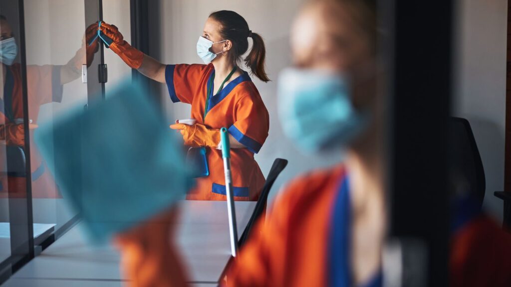 two women cleaning a classroom