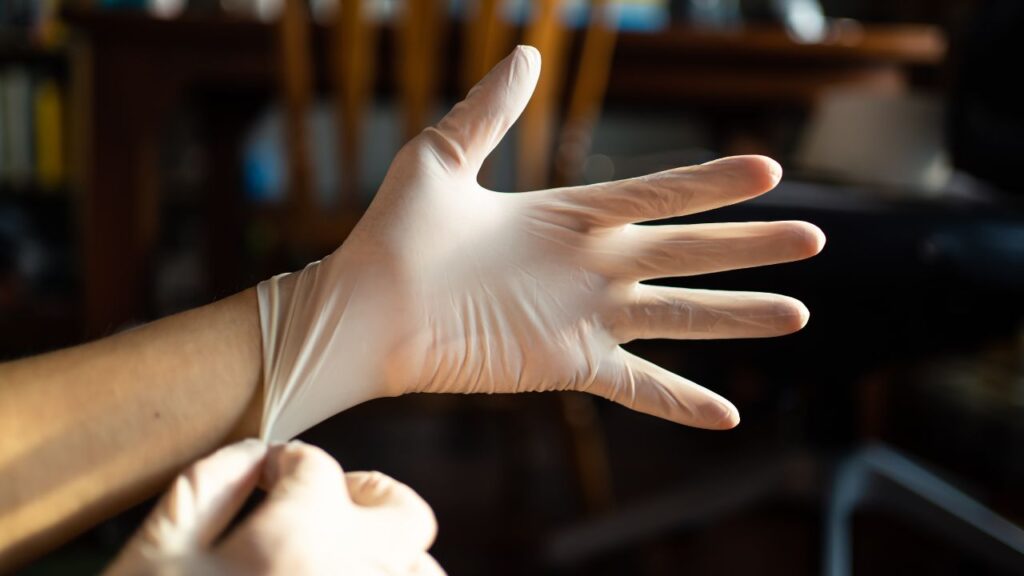 hands with disposable gloves