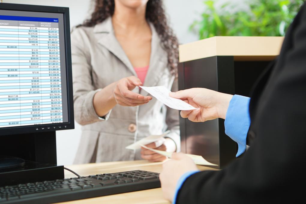 Bank receptionist handing money