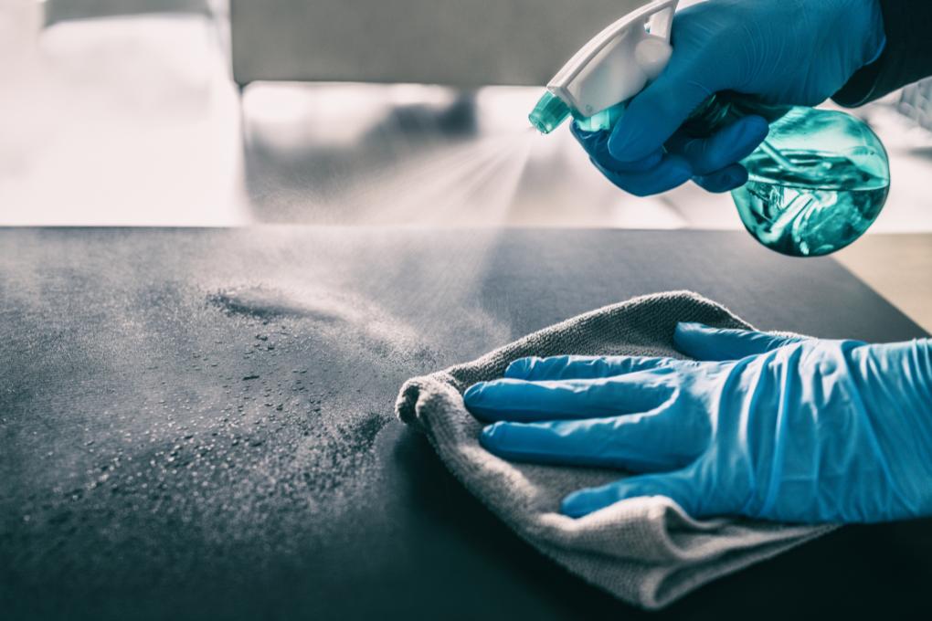 close up of hands cleaning a surface