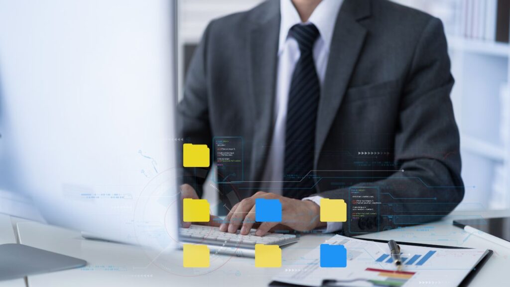 man-working-on-computer-with-file-icons-in-front
