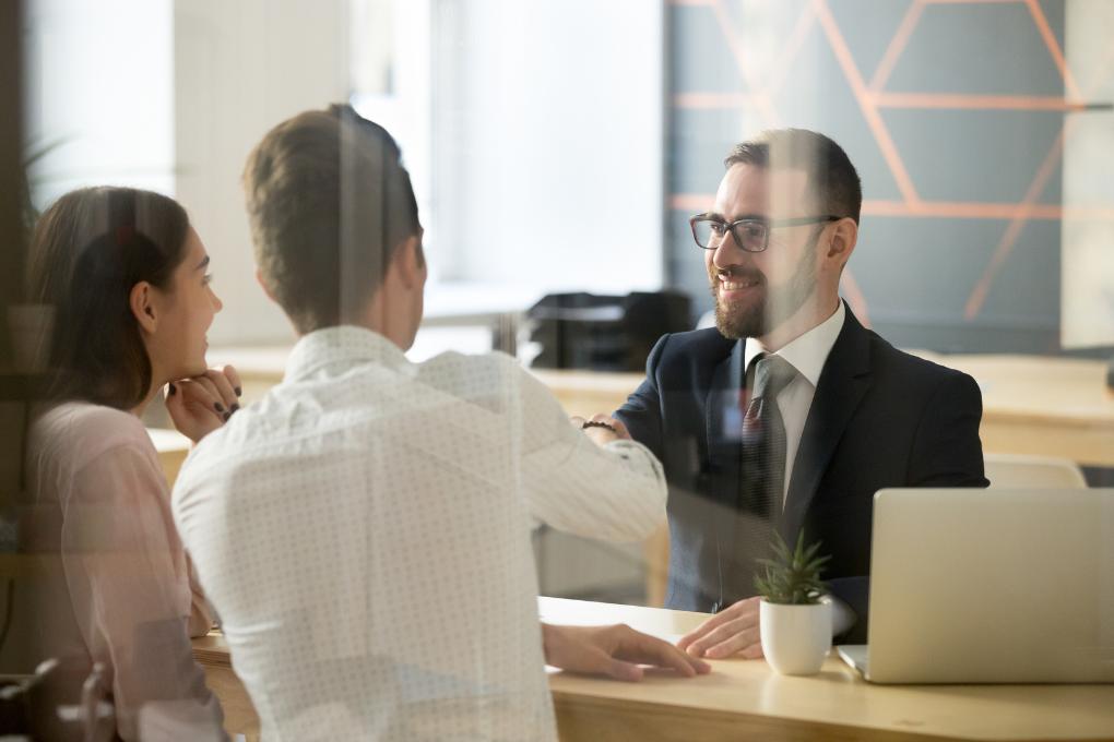 satisfied clients with smiling worker