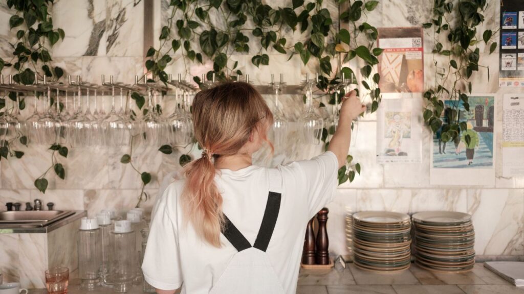 woman-arranging-glasses-back-on-hack