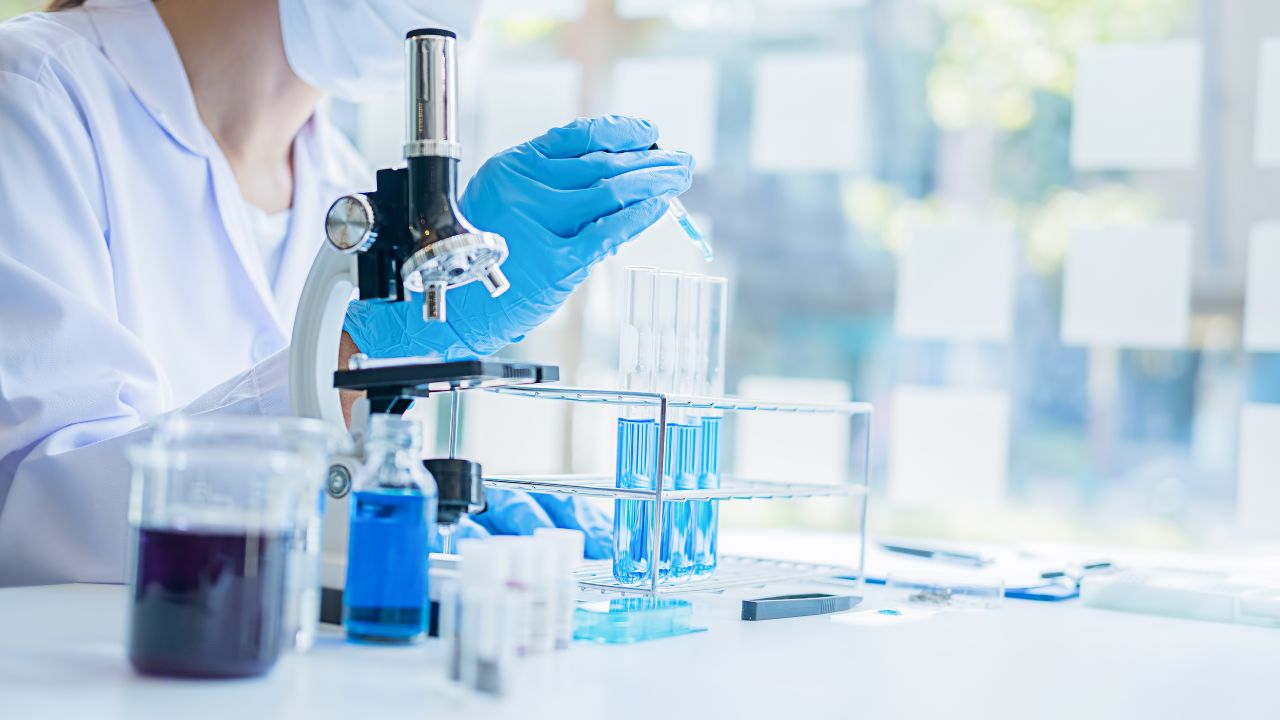 woman-on-a-lab-adding-liquid-to-test-tube