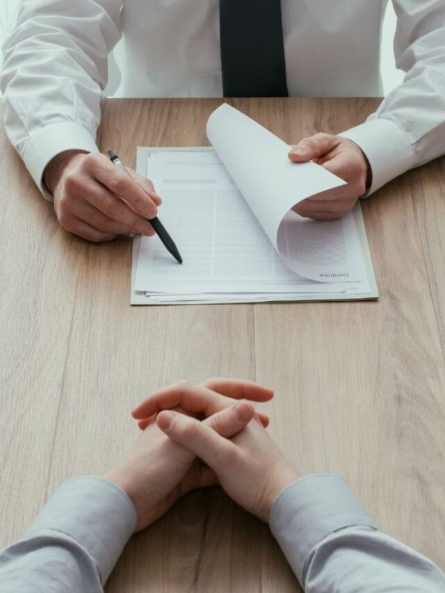 two-people-sitting-across-one-with-papers